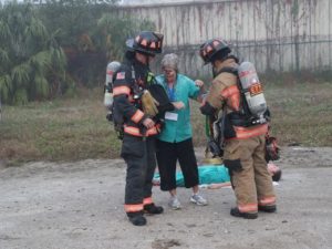 Two Firefighters assisting someone